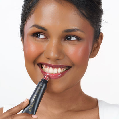Berry_Rush Indian woman with deep skin applying Glazient Berry Rush berry red lip gloss