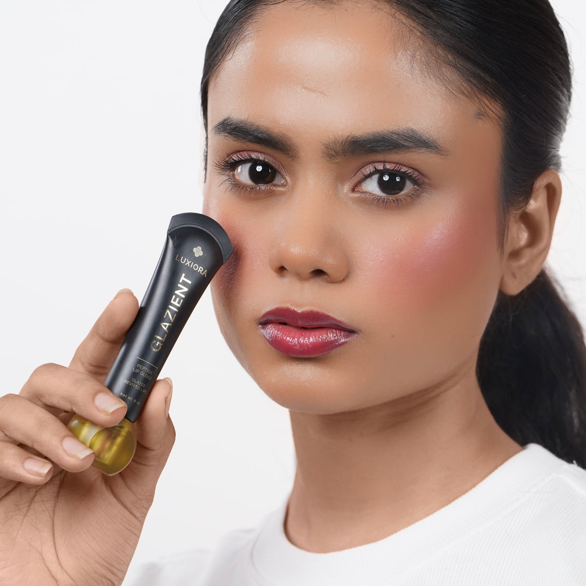 Berry_Rush Indian woman with medium skin applying Glazient Berry Rush berry red lip gloss
