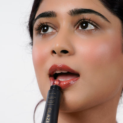 Warm_Caramel Indian woman with fair skin applying Glazient Warm Caramel nude lip gloss
